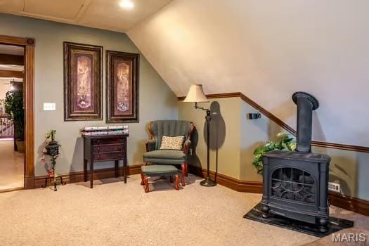 762 Crider Ln, Union, MO 63084 - sitting room featuring a wood stove, carpet, vaulted ceiling, and baseboards