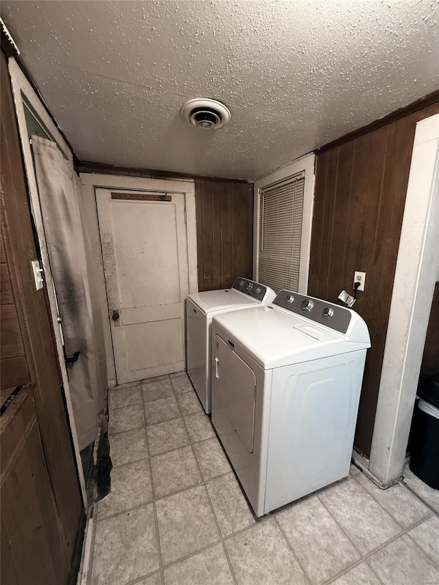 610 W Main St, Sullivan, MO 63080 - laundry area with independent washer and dryer, a textured ceiling, and wood walls