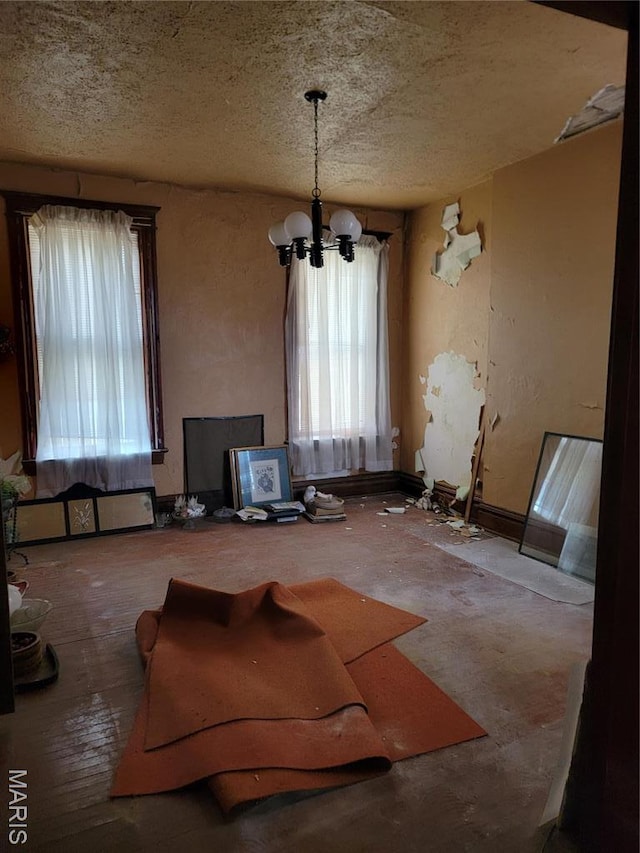 4453 Athlone Ave, Saint Louis, MO 63115 - dining space featuring a chandelier and a textured ceiling