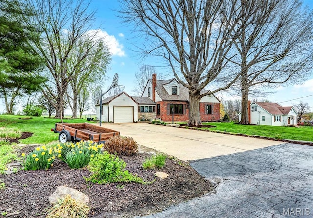 765 Pottery Tower Ln, Washington, MO 63090 - view of front of home with concrete driveway, a chimney, a garage, and a front yard