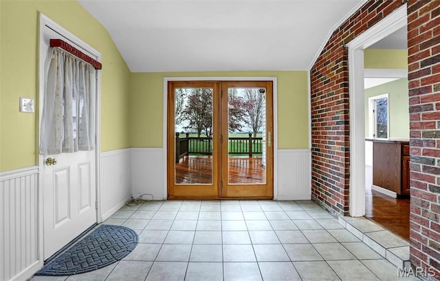 765 Pottery Tower Ln, Washington, MO 63090 - entryway featuring lofted ceiling, a wainscoted wall, tile patterned flooring, and french doors