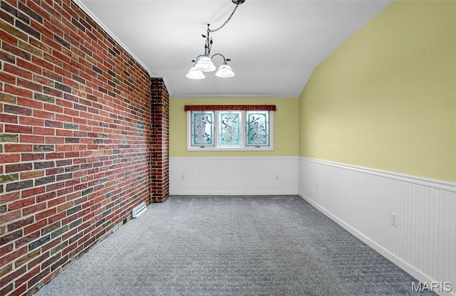 765 Pottery Tower Ln, Washington, MO 63090 - carpeted empty room featuring wainscoting, brick wall, and a chandelier