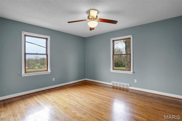 765 Pottery Tower Ln, Washington, MO 63090 - spare room featuring wood finished floors, a ceiling fan, baseboards, and a textured ceiling