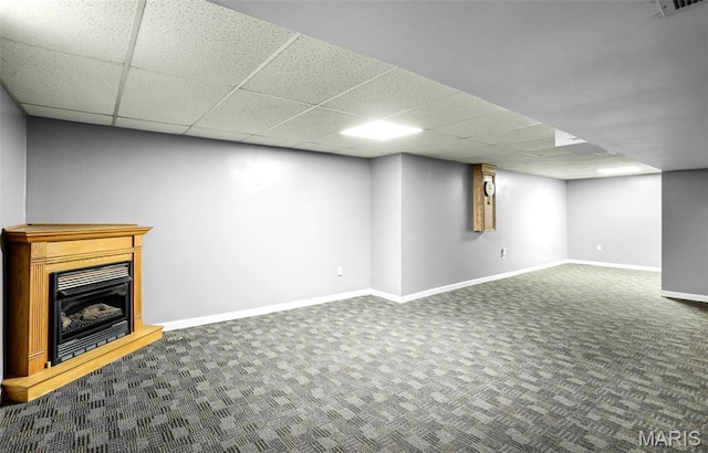 765 Pottery Tower Ln, Washington, MO 63090 - finished below grade area with a paneled ceiling, carpet, baseboards, and a fireplace with raised hearth
