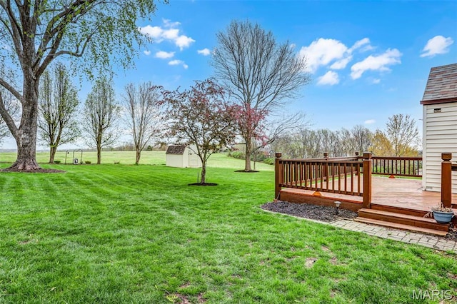 765 Pottery Tower Ln, Washington, MO 63090 - view of grassy yard featuring a deck, a storage shed, and an outdoor structure