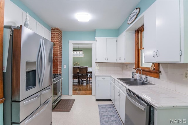 110 W Scioto St, St James, MO 65559 - kitchen with stainless steel appliances, backsplash, and white cabinetry