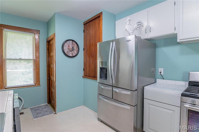110 W Scioto St, St James, MO 65559 - kitchen featuring appliances with stainless steel finishes, tile countertops, and white cabinets