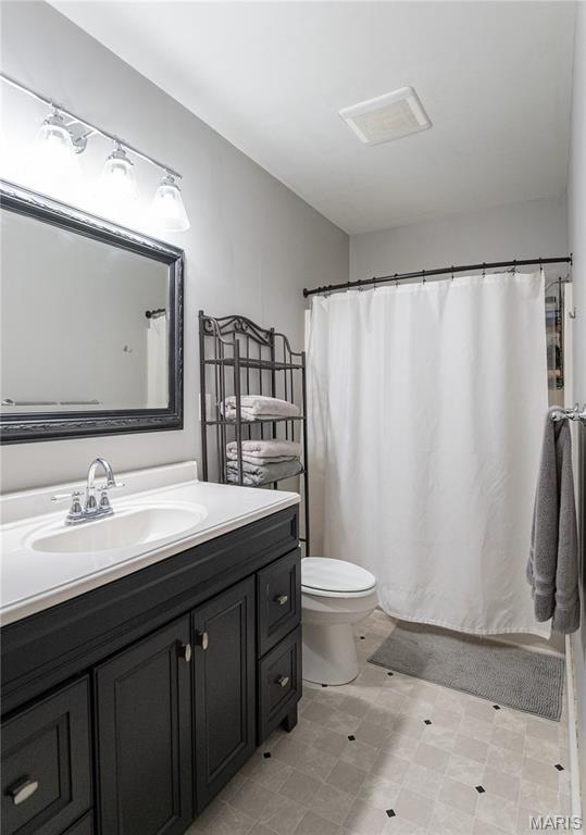110 W Scioto St, St James, MO 65559 - full bathroom with vanity and a shower with shower curtain