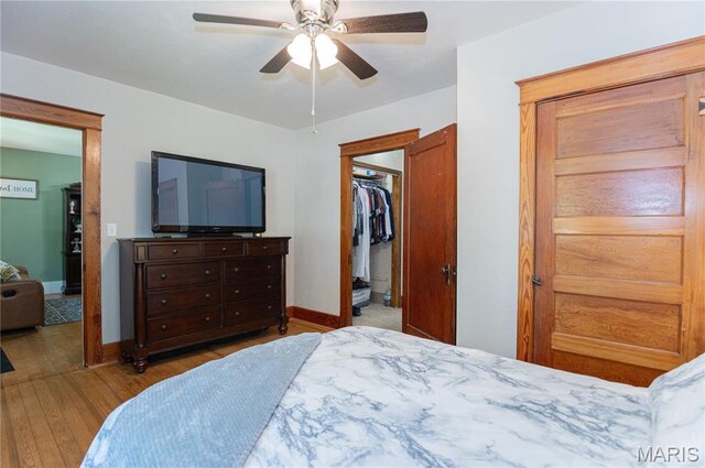 110 W Scioto St, St James, MO 65559 - bedroom with wood finished floors, a spacious closet, a ceiling fan, and a closet