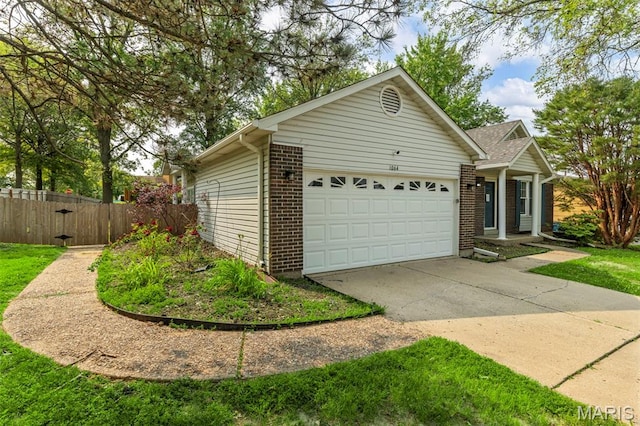 1064 Pinecone Trl, Florissant, MO 63031 - view of front of property featuring a garage, brick siding, and driveway
