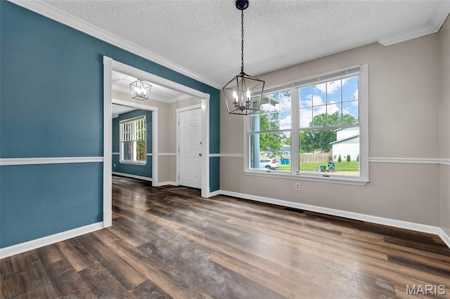 1064 Pinecone Trl, Florissant, MO 63031 - unfurnished dining area with a chandelier, ornamental molding, a textured ceiling, wood finished floors, and baseboards