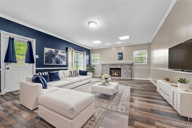 1064 Pinecone Trl, Florissant, MO 63031 - living area with crown molding, wood finished floors, baseboards, and a brick fireplace