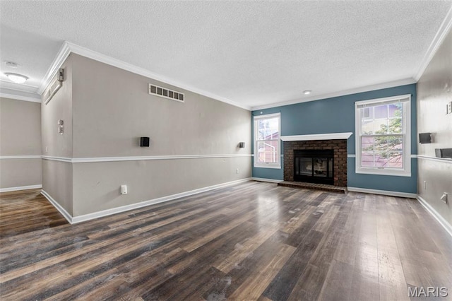 1064 Pinecone Trl, Florissant, MO 63031 - unfurnished living room featuring crown molding, wood finished floors, a textured ceiling, baseboards, and a brick fireplace