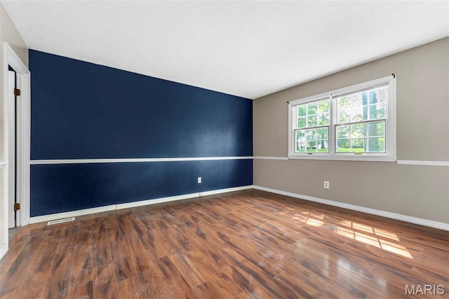 1064 Pinecone Trl, Florissant, MO 63031 - unfurnished room with wood finished floors and baseboards