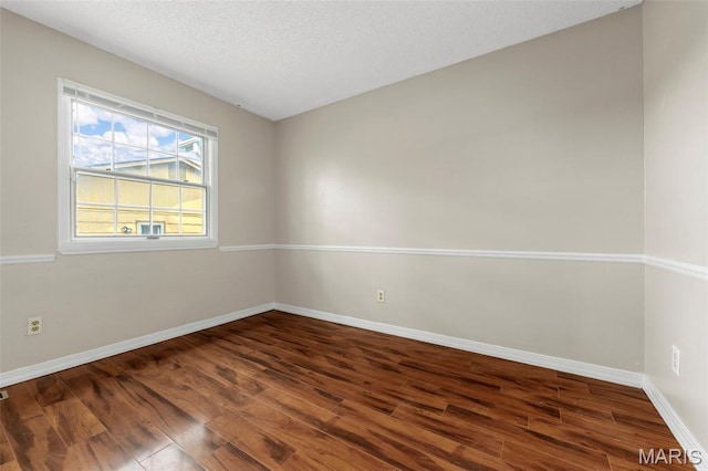 1064 Pinecone Trl, Florissant, MO 63031 - empty room with wood finished floors, baseboards, and a textured ceiling