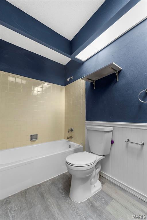 1064 Pinecone Trl, Florissant, MO 63031 - bathroom with wood finished floors, toilet, a wainscoted wall, and bathing tub / shower combination