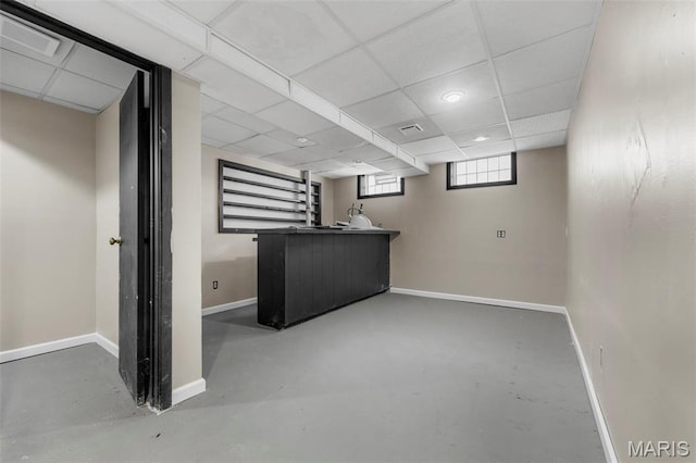 1064 Pinecone Trl, Florissant, MO 63031 - below grade area with baseboards, wet bar, recessed lighting, and a paneled ceiling