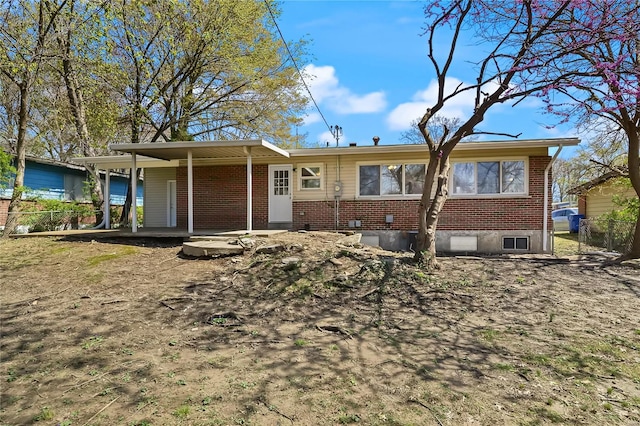 1315 Hialeah Pl, Florissant, MO 63033 - rear view of property featuring brick siding, fence, and covered porch