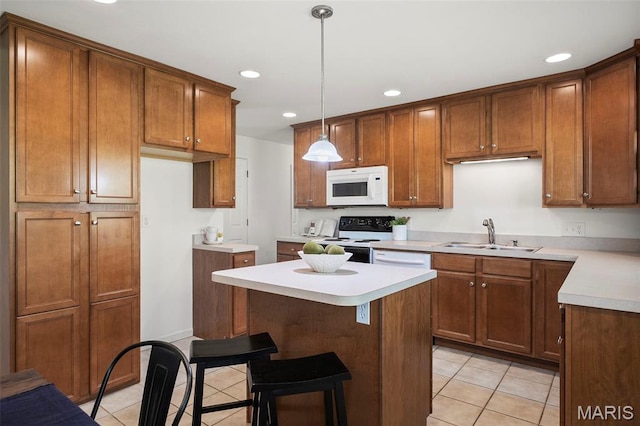 9523 Hale Dr, Saint Louis, MO 63123 - kitchen with white microwave, a sink, range with electric stovetop, light tile patterned floors, and recessed lighting