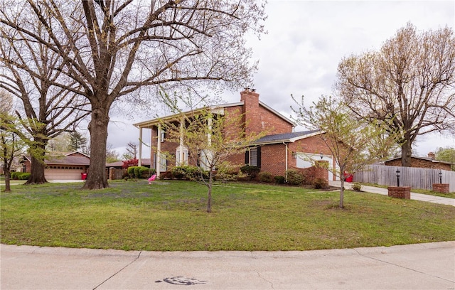 112 Summer Dr, Sikeston, MO 63801 - view of front of home with a chimney, a garage, and brick siding