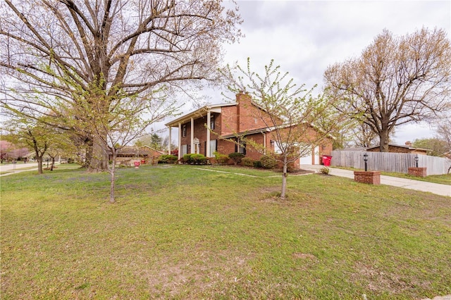 112 Summer Dr, Sikeston, MO 63801 - view of front of property featuring concrete driveway, brick siding, a chimney, and an attached garage