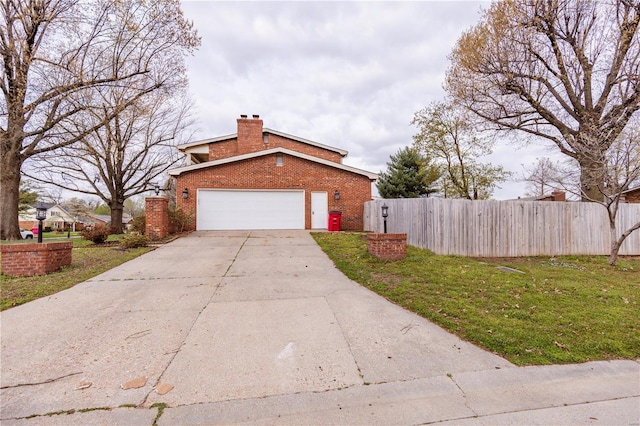 112 Summer Dr, Sikeston, MO 63801 - view of side of home with brick siding, a chimney, concrete driveway, and an attached garage