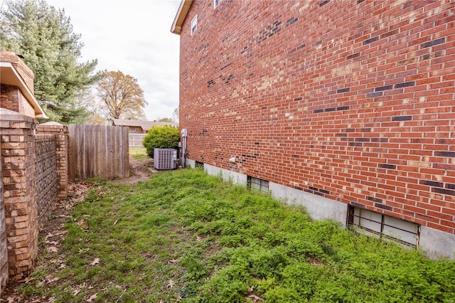 112 Summer Dr, Sikeston, MO 63801 - view of home's exterior featuring fence, central AC unit, and brick siding