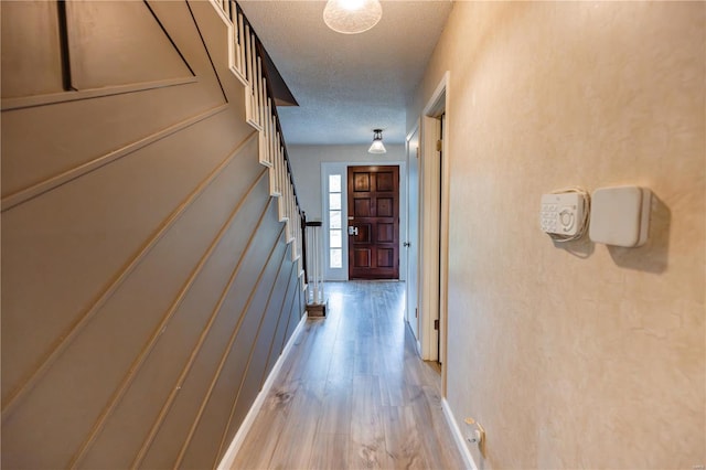 112 Summer Dr, Sikeston, MO 63801 - hallway featuring a textured ceiling, light wood-type flooring, and stairs