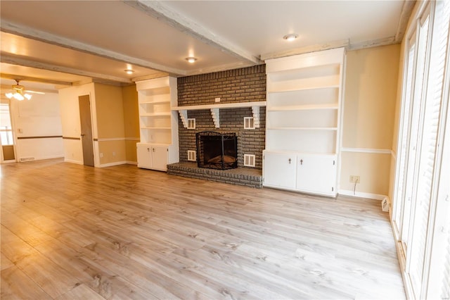 112 Summer Dr, Sikeston, MO 63801 - unfurnished living room with beamed ceiling, light wood-type flooring, baseboards, and a brick fireplace