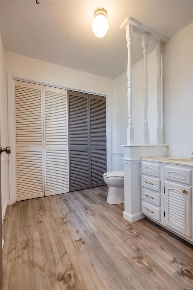 112 Summer Dr, Sikeston, MO 63801 - bathroom with toilet, wood finished floors, baseboards, and a sink