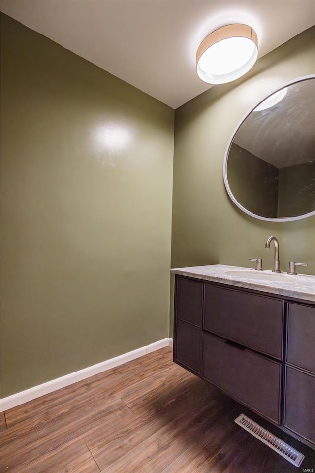 112 Summer Dr, Sikeston, MO 63801 - bathroom featuring wood finished floors, baseboards, and vanity