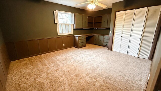 112 Summer Dr, Sikeston, MO 63801 - unfurnished office with built in desk, ceiling fan, light colored carpet, and wainscoting