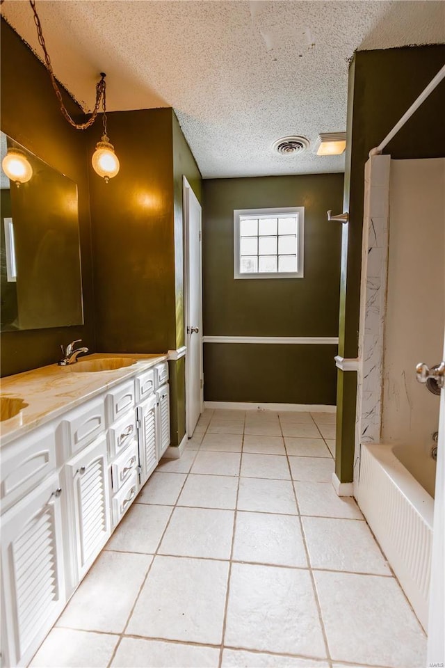112 Summer Dr, Sikeston, MO 63801 - full bath with a textured ceiling, tile patterned floors, double vanity, and tub / shower combination