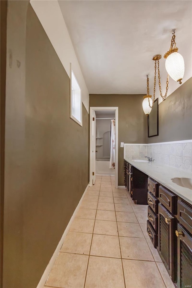 112 Summer Dr, Sikeston, MO 63801 - full bath featuring tile patterned floors, a shower with shower curtain, double vanity, and a bathtub