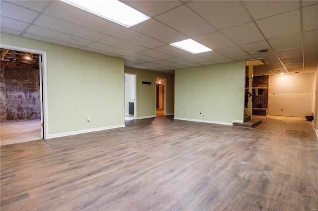 112 Summer Dr, Sikeston, MO 63801 - basement featuring stairs, wood finished floors, a drop ceiling, baseboards, and wood walls