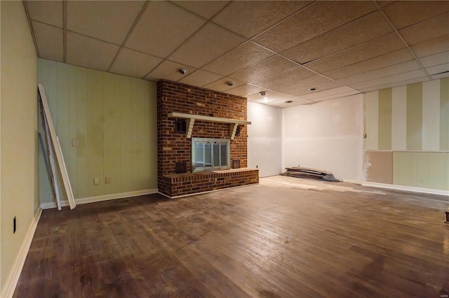 112 Summer Dr, Sikeston, MO 63801 - unfurnished living room with a drop ceiling, wood finished floors, baseboards, and a fireplace