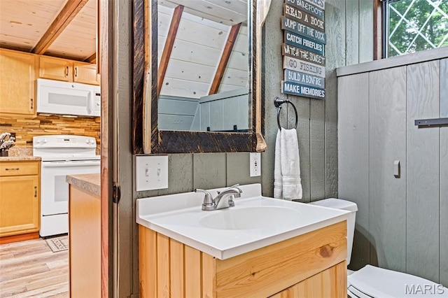 bathroom with wood finished floors, wooden ceiling, toilet, vanity, and backsplash
