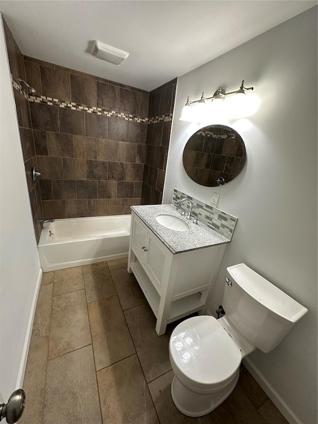 1612 California Ave, Collinsville, IL 62234 - full bathroom with vanity, washtub / shower combination, toilet, baseboards, and tile patterned flooring