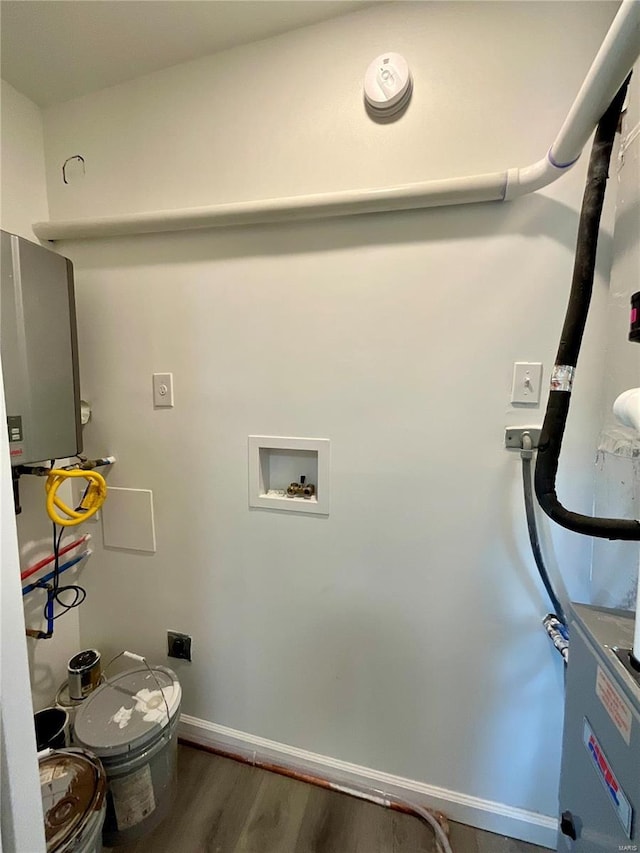 1612 California Ave, Collinsville, IL 62234 - washroom with electric dryer hookup, washer hookup, wood finished floors, tankless water heater, and baseboards