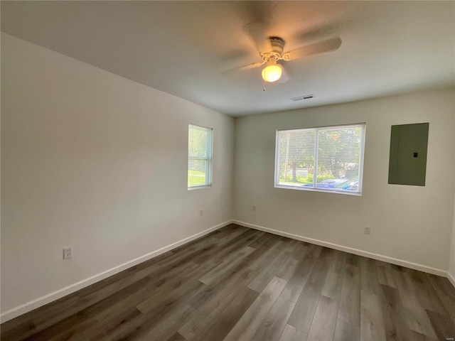 1612 California Ave, Collinsville, IL 62234 - empty room with electric panel, dark wood finished floors, a ceiling fan, and baseboards