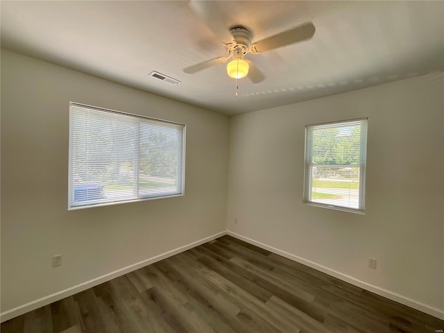 1612 California Ave, Collinsville, IL 62234 - unfurnished room with dark wood-type flooring, a ceiling fan, and baseboards