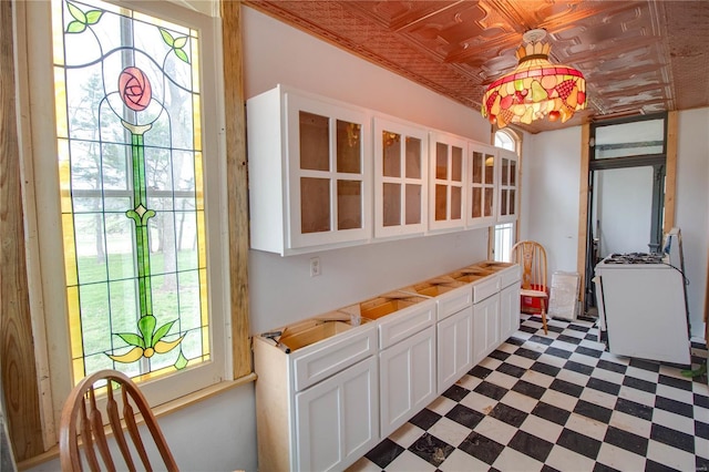 1508 State Route 140, Smithboro, IL 62284 - kitchen with an ornate ceiling, plenty of natural light, white cabinetry, dark flooring, and glass insert cabinets