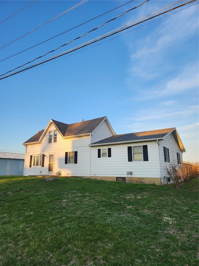back of property featuring a lawn