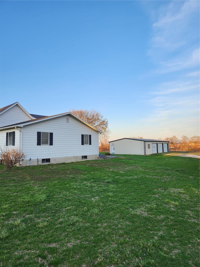 view of home's exterior with a yard and a garage