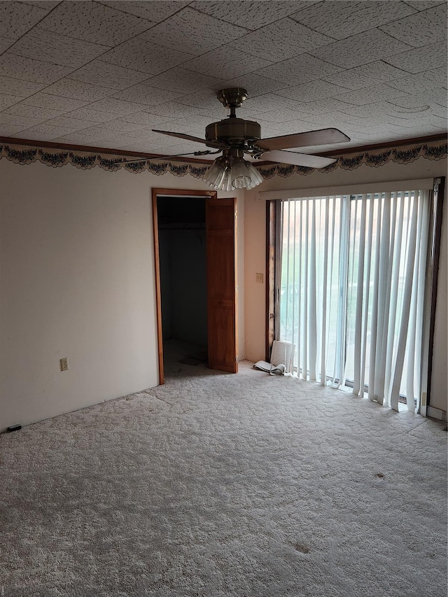 unfurnished room featuring carpet floors and ceiling fan