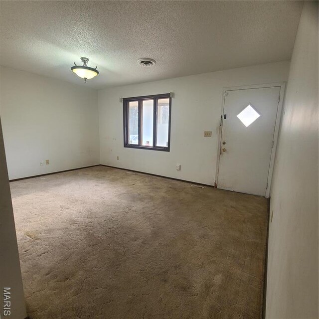 23026 Reporter Rd, Waynesville, MO 65583 - carpeted entrance foyer featuring a textured ceiling and baseboards