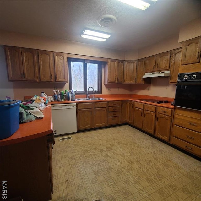 23026 Reporter Rd, Waynesville, MO 65583 - kitchen featuring black appliances, a sink, under cabinet range hood, brown cabinetry, and light floors