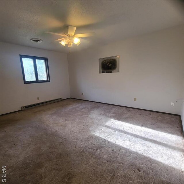 23026 Reporter Rd, Waynesville, MO 65583 - empty room with baseboard heating, carpet, ceiling fan, and baseboards