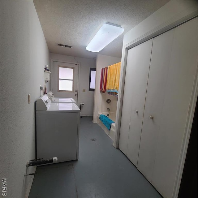 23026 Reporter Rd, Waynesville, MO 65583 - laundry area featuring washing machine and clothes dryer and a textured ceiling