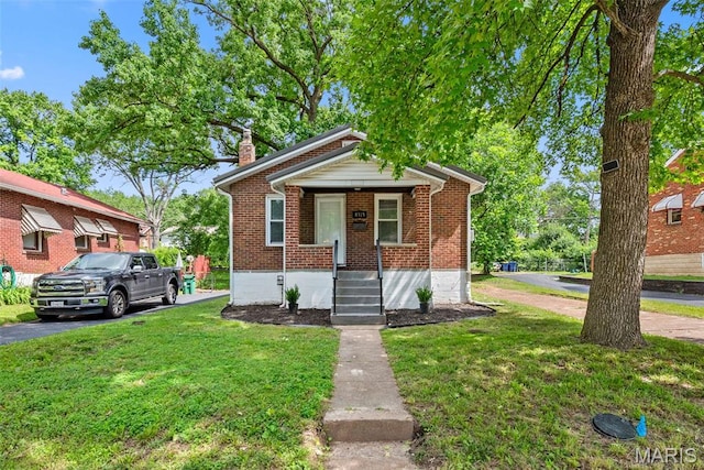 8315 Jefferson Ave, Vinita Park, MO 63114 - bungalow featuring a chimney, brick siding, a front yard, and a porch